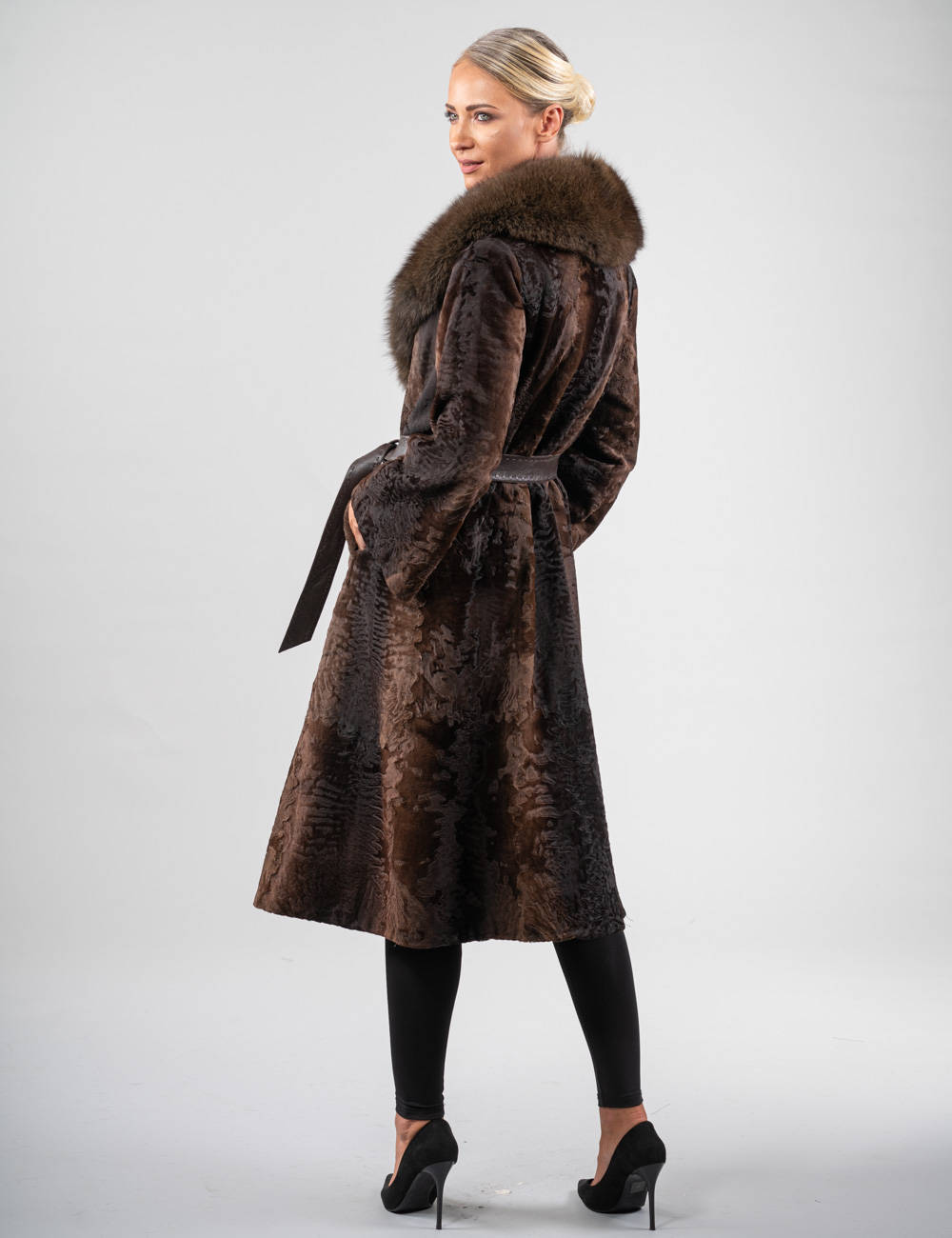 Elegant long astrakhan fur coat with fluffy collar and leather belt ...